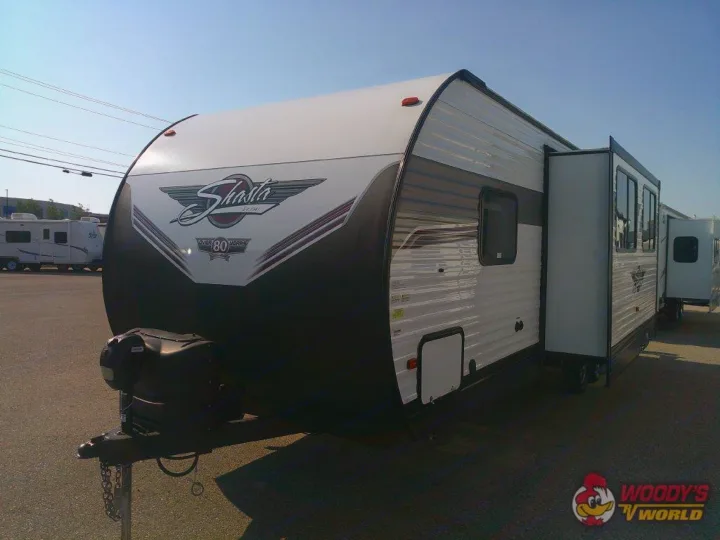 This white & black Shasta travel trailer RV, perfect for rv rental or purchase, showcases a slide-out feature.. Forest River Shasta 2022