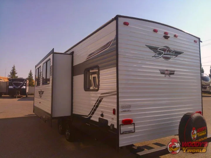 White Shasta travel trailer RV with extended slide-out. Ready for your next rv rental adventure! Woody's branding visible.. Forest River Shasta 2022