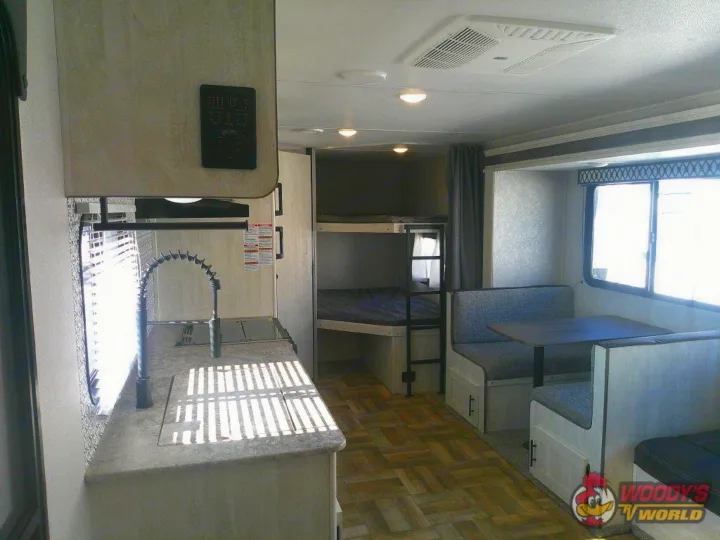 Spacious RV rental interior featuring kitchen, dinette, and bunk beds for comfortable travel adventures.. Forest River Shasta 2022