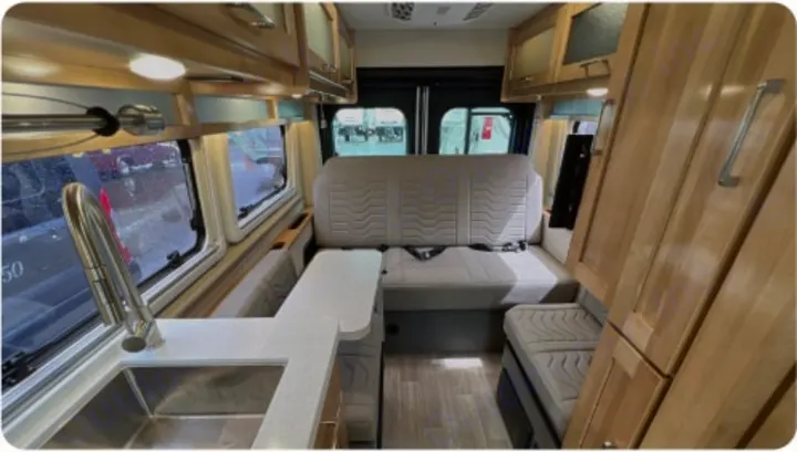 Inside this RV rental: a modern kitchen with sink, versatile seating, and ample wood storage. A well-equipped mobile home.. Coachman Nova 2024