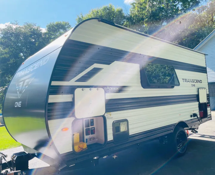 Explore the outdoors! This light-colored Transcend One travel trailer is ideal for an RV rental getaway.. Grand Design Transcend One 151BH 2025