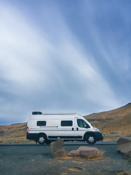 White Winnebago Solis rv rental parked in a vast, arid landscape under a dramatic sky, ideal for a scenic road trip.. Other Other 2022