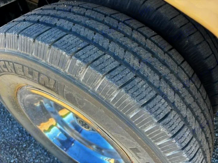 Michelin dual tires and a shiny chrome wheel on an RV rental, showing excellent tread.. Thor Axis 2016