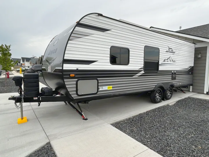 Modern Jayco Jay Flight travel trailer parked on concrete, available for RV rental.. Jayco Jay Flight 2024