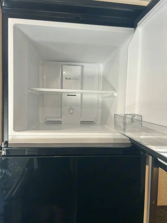 Empty, pristine refrigerator interior, ready for your adventure in this RV rental. Features "Multi Airflow" and freezer control.. Jayco Jay Flight 2024