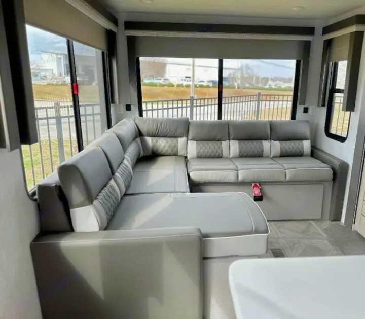 Relax in this spacious, modern L-shaped sofa in your RV rental. Features sleek gray interior & large windows.. Forest River Salem 2024