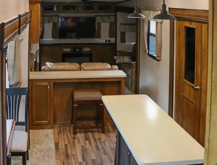 Spacious RV rental interior featuring a cozy living area, modern kitchen counter, and inviting dining space.. Forest River Coachmen Chaparral 2018
