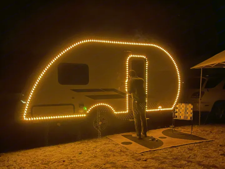 This RV rental brightens the night, its tear-drop shape outlined by numerous warm string lights, creating a unique campsite glow.. Braxton Creek Bushwhacker Plus 2022