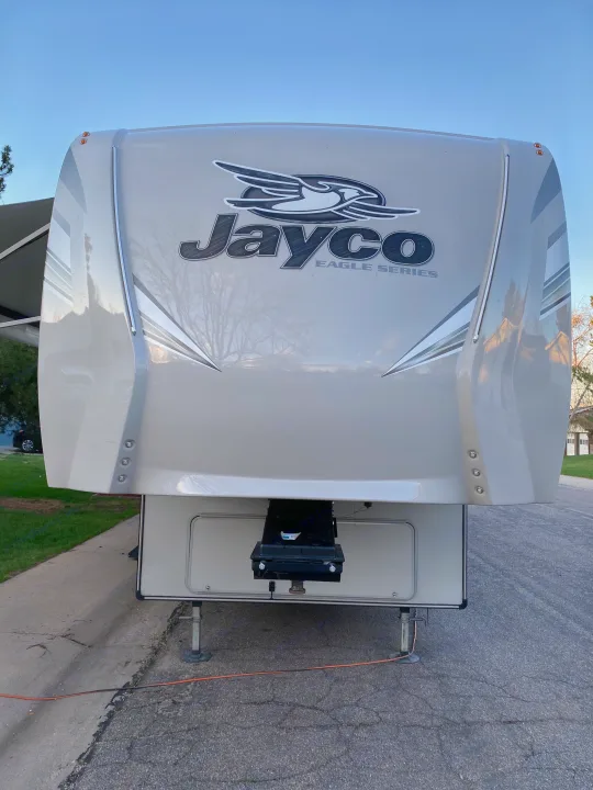 Front view of a Jayco Eagle Series fifth-wheel RV, perfect for your next rv rental adventure. Parked on asphalt.. Jayco Eagle 2020