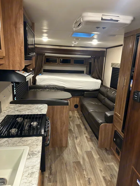 Bright RV rental interior featuring a kitchen, dinette, sofa, and bed. Perfect for your travels.. Jayco Jay Flight 2018
