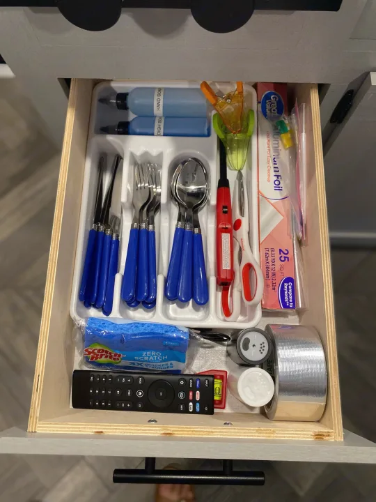 An organized RV rental kitchen drawer features cutlery, dish soap, foil, and essentials, optimizing space for travel.. Forest River Salem FSX 2022
