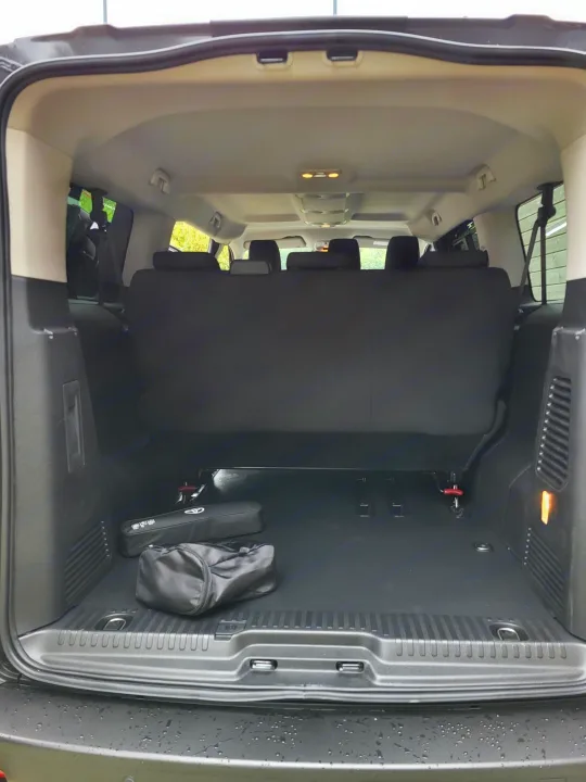 View of an open spacious vehicle trunk with upright rear seats and a large floor. Ready for your next rv rental adventure!. TOYOTA PROACE VERSO 2024