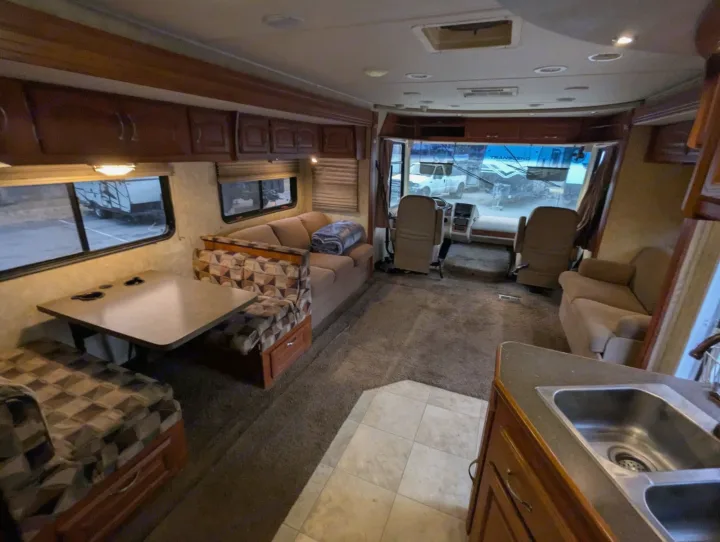 Inside a comfortable RV rental: ample living space, dinette, kitchen counter, & front cockpit.. Coachmen Mirada 2009