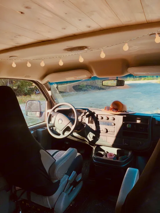 Sunny rv rental interior: custom wood ceiling, ambient string lights, dash with hat & sunglasses. Ready for adventure!. Gmc Savanna 2016