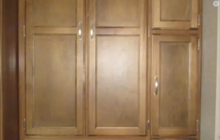 Multiple wooden storage cabinets with silver handles, showcasing typical interior storage in an RV rental.. Keystone Springdale 2016