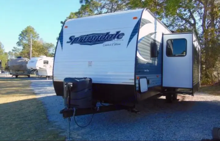 White Springdale travel trailer with extended slide-out, ideal for your next RV rental adventure at a campground.. Keystone Springdale 2016