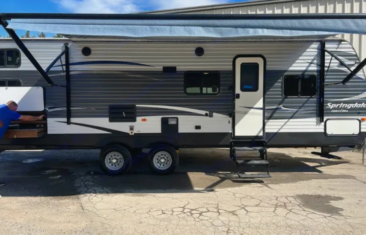 Experience comfort with this travel trailer rv rental. Features an extended awning, outdoor kitchen, and easy-access steps.. Keystone Springdale 2016
