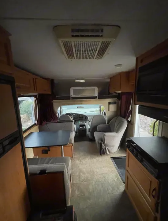 Spacious RV rental interior with kitchen, dining area, and cozy living space, extending to the front driver's cabin.. Four Winds Majestic 2007
