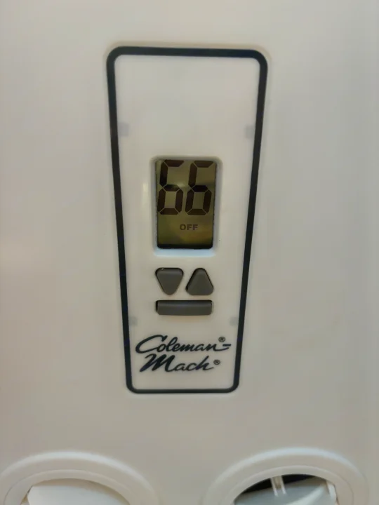 Coleman Mach digital thermostat in an RV rental, showing 66 and OFF, with up/down and mode buttons below.. Thor Majestic 2015