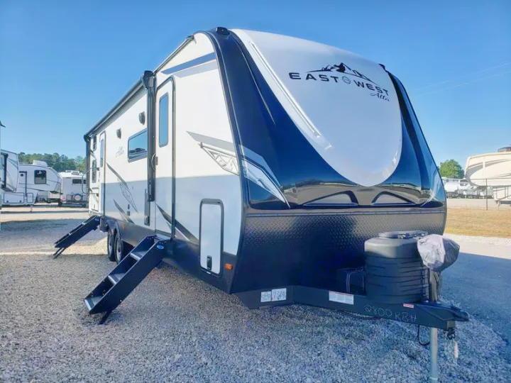 White & black East West Alta travel trailer, steps extended, ready for RV rental. Perfect for your next adventure.. East to West Alta 2024
