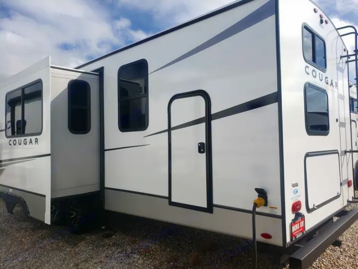 Spacious Cougar travel trailer RV rental with slide-out deployed for extra room. Perfect for family camping.. Keystone RV Cougar 2024