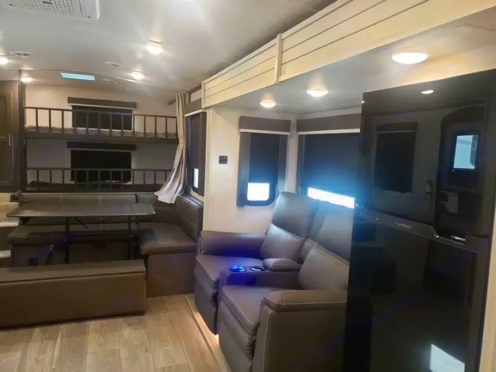 This rv rental features a modern living space with bunk beds, comfortable recliners, and a dinette for family adventures.. Keystone RV Cougar 2024