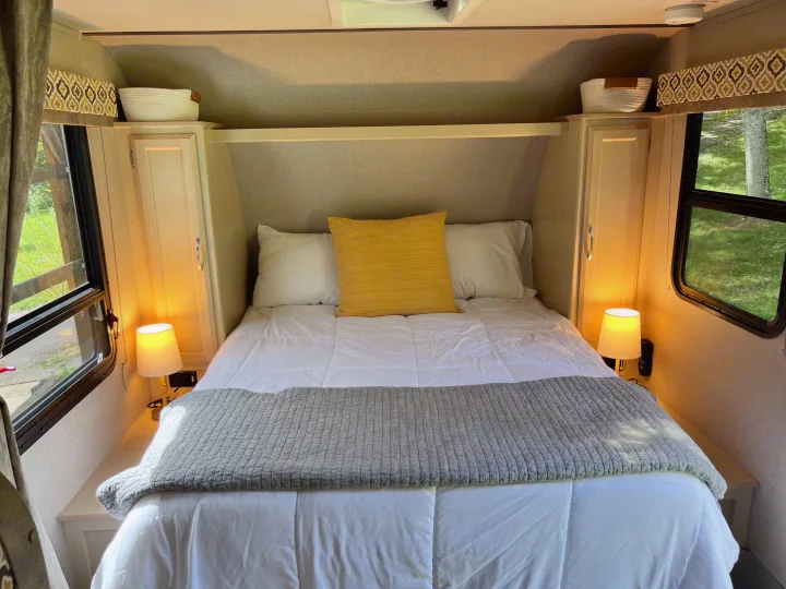 Relax in this comfortable RV rental bedroom featuring a cozy bed, ambient lighting, and storage.. Winnebago Micro Minnie 2306BHS 2019