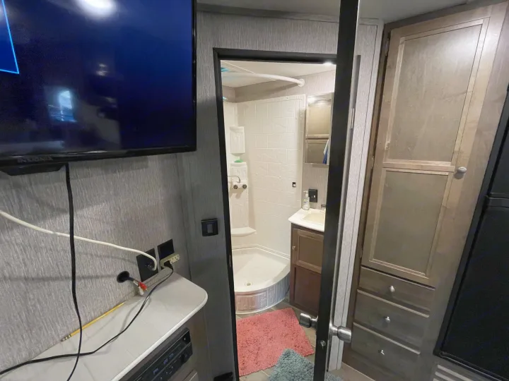 RV rental: step inside a well-equipped interior featuring a compact bathroom with shower and a cozy living area.. Coleman Lantern 2019
