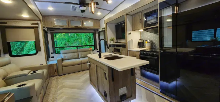 Modern RV rental: Spacious interior with full kitchen, comfy recliners & sofa, perfect for adventures.. Forest River Hemisphere 2022
