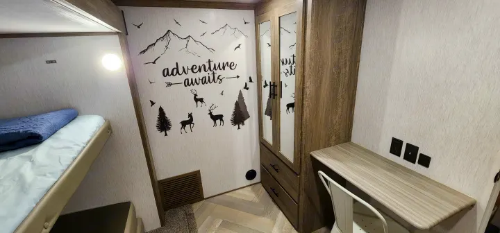 Nature-themed RV rental interior with bunk beds, a wardrobe, and a dedicated workspace.. Forest River Hemisphere 2022
