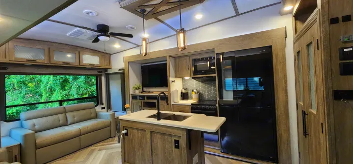 Spacious RV rental interior with a modern kitchen, comfortable living area, and large window view.. Forest River Hemisphere 2022