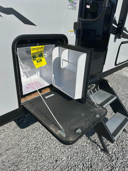 RV rental with outdoor mini-fridge, pull-down counter, and steps for convenient outdoor living.. Forest River Cherokee Wolf Pup 2025