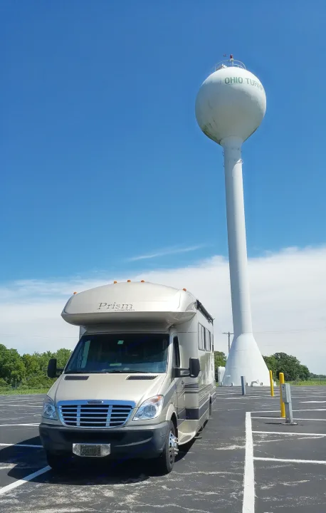 Coachmen Prism RV rental parked under the iconic Ohio Turnpike water tower, on a clear day.. Coachmen Prism 2009