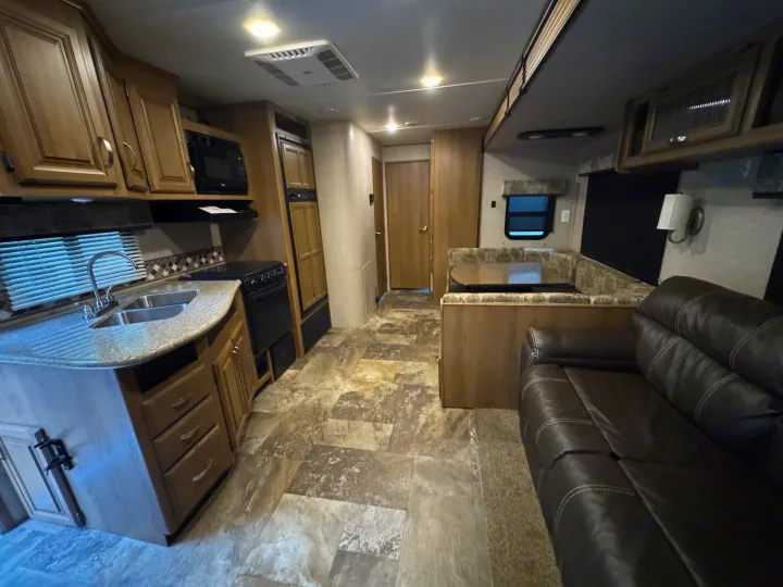 Spacious RV rental interior with kitchen, dinette, and cozy sofa. Perfect for your travels.. Crossroads RV Cruiser Aire 2016