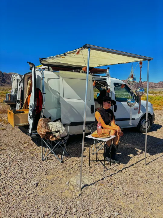 Enjoying desert van life with an RV rental: awning, pull-out kitchen, & disco balls. Perfect for boondocking.. Dodge Promaster City 2016