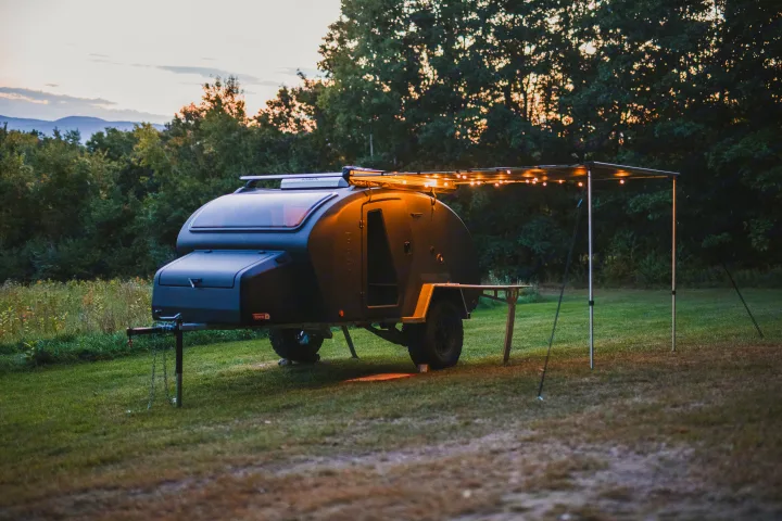 Scenic RV rental: This cozy teardrop camper with illuminated awning and table offers perfect outdoor escape.. Escapod Topo 2 Voyager 2024