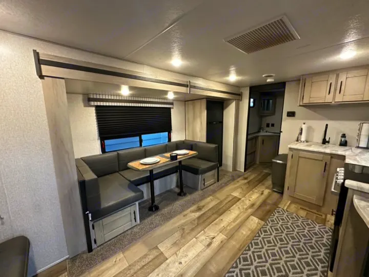 Explore this RV rental's inviting interior: an L-shaped dinette, kitchen, and ample living space.. Connect SE 2022