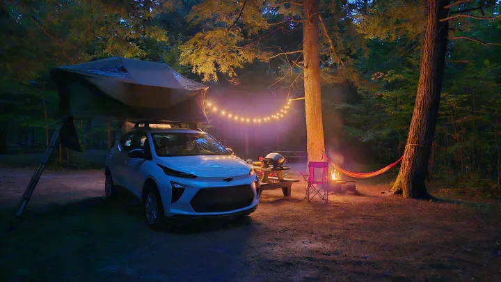 Cozy camping night. Consider an EV with rooftop tent for your next RV rental alternative, complete with bonfire & string lights.. Chevrolet Other 2023