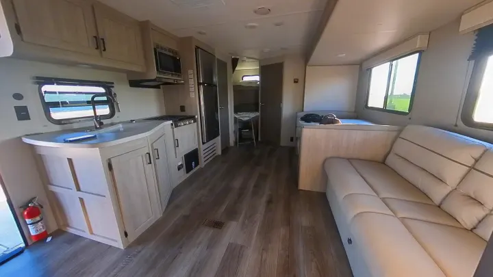 Inside a modern RV rental: light-filled kitchen, comfy living area, and bunk room. Ready for adventures on the road.. Coachmen Catalina 2024