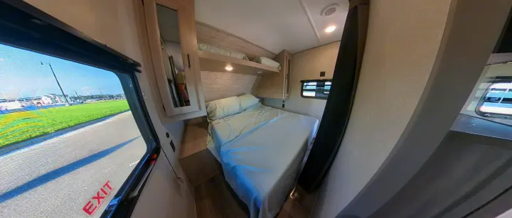 RV rental: Inside a spacious bunkhouse RV, featuring a comfortable bed and overhead bunk for family adventures.. Coachmen Catalina 2024