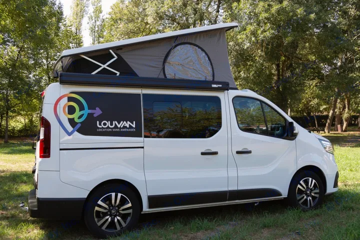White pop-top camper van for rv rental parked on grass, ideal for camping adventures.. HANROAD TREK 5 2026