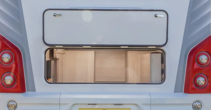 Ready for your RV rental adventure! Rear exterior storage hatch open on a camper, revealing a spacious wood-lined interior.. Auto-Trail C71 Expedition 2025