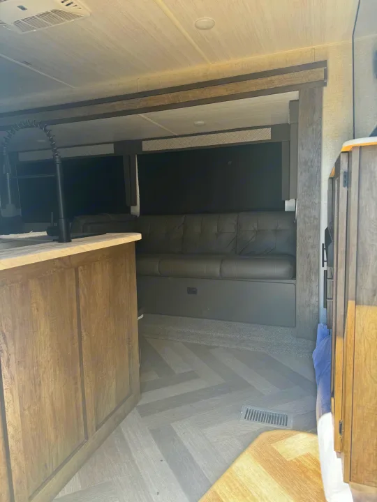 This spacious RV rental interior features a modern kitchen, comfy seating, and wood-look floors.. Forest River Other 2021