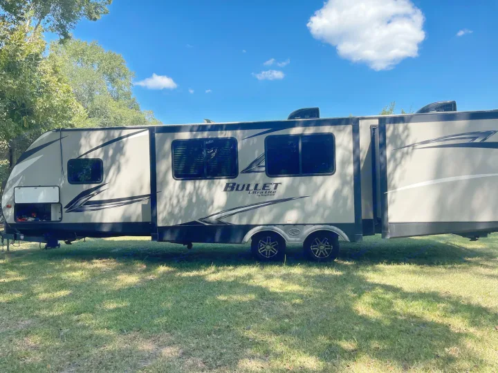 Bullet Ultra Lite travel trailer RV rental, parked on grass. Ready for your next camping adventure!. Keystone RV Bullet Ultra Lite 2020