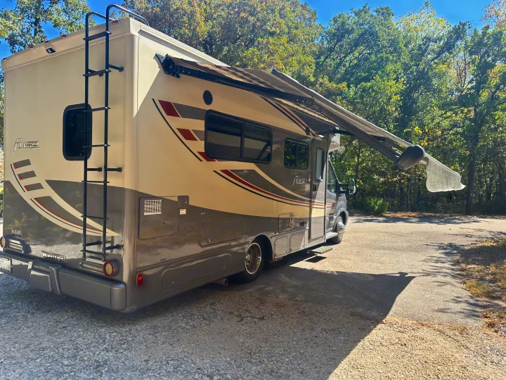 Enjoy the outdoors with this Winnebago Fuse RV rental, featuring an extended awning and rear ladder.. Winnebago Fuse 2017