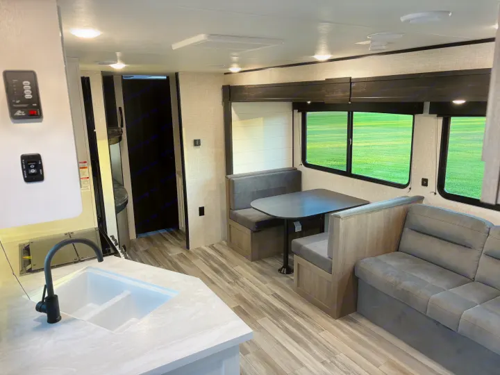 Spacious RV rental interior with a modern kitchen island, dinette, and cozy living area, ideal for your next camper adventure.. Jayco Jay Flight SLX 2024