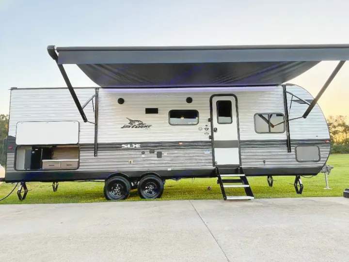 This Jay Flight SLX travel trailer, perfect for an rv rental, features an extended awning and outdoor kitchen.. Jayco Jay Flight SLX 2024
