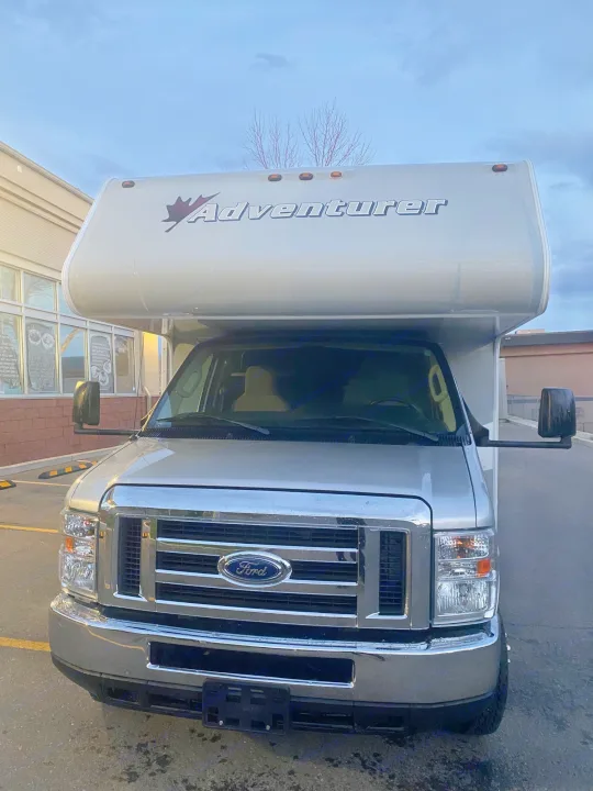Front view of a silver Adventurer Class C rv rental, a Ford motorhome ready for your travels.. Adventurer Adventurer Motorhome 2017