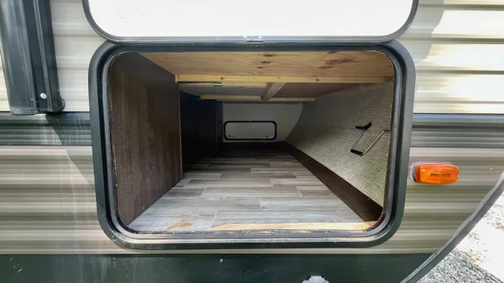 Spacious open pass-through storage bay of an RV rental, ready for your camping gear.. Forest River Wildwood 2019