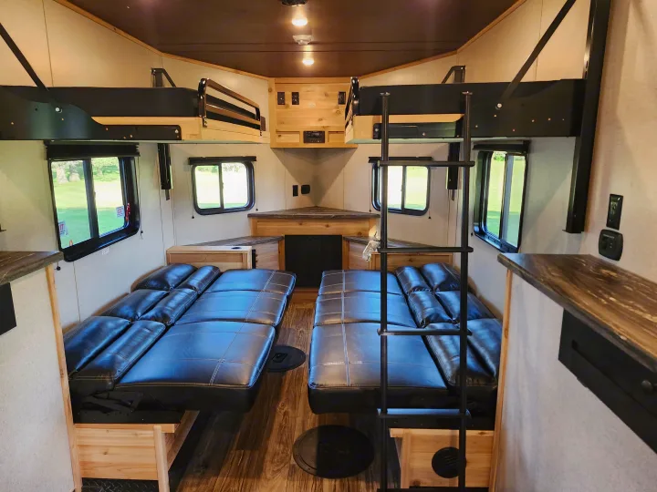 RV rental: RV interior with two lower convertible beds, two upper bunk beds, and wooden storage/counter.. Glacier Ice House 17RBLE 2023